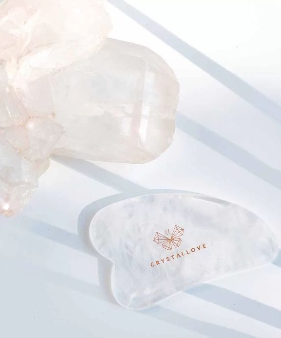 Tabla de masaje facial gua sha de cristal de roca con propiedades limpiadoras Crystallove